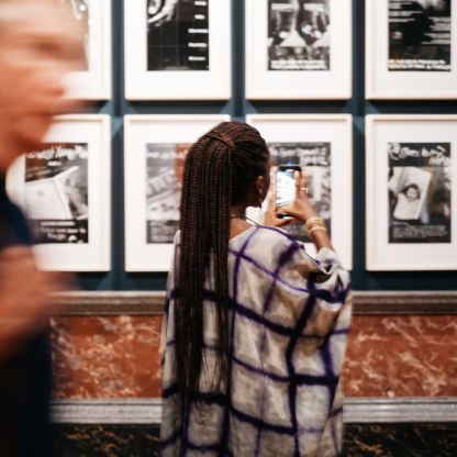 A highlight image for woman in gallery taking photo